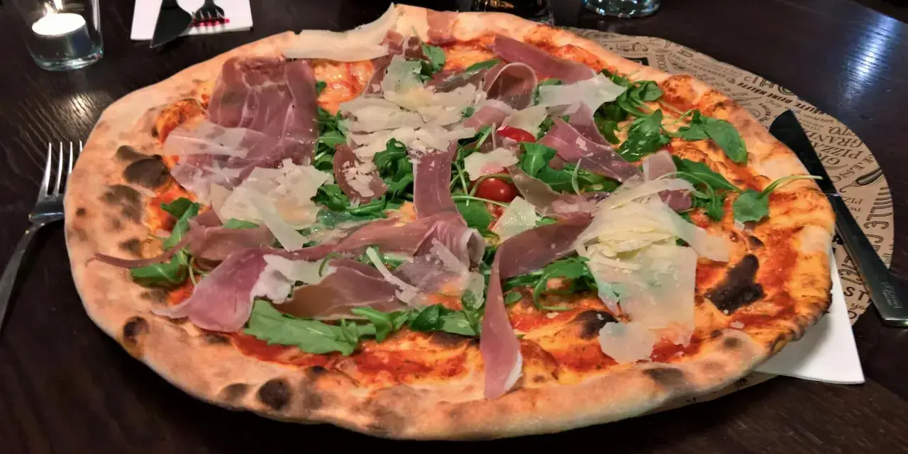 Italienische Pizza mit Prosciutto, Rucola und Parmesan. Ein köstliches italienisches Pizza Rezept, das man probieren muss!