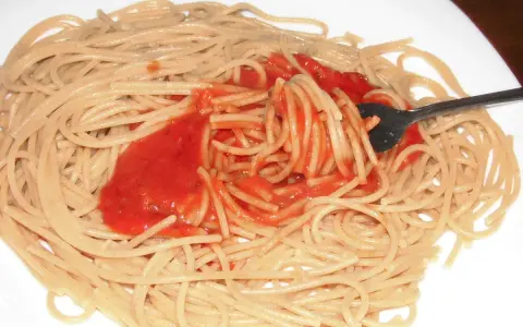 Spaghetti mit bester Tomatensauce, die mit einer Gabel aufgewirbelt wird. Ein einfaches, aber köstliches Gericht.