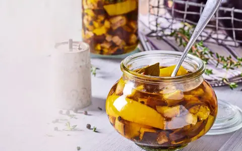 Eingemachte Auberginen in einem Glas, bereit zum Einkochen. Mit Kräutern und Gewürzen verfeinert.